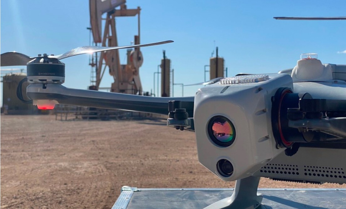 close up of drone with OGI payload in front of upstream oil and gas facility